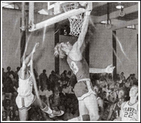 Gary Silver doing a jump and dunk from under the net
